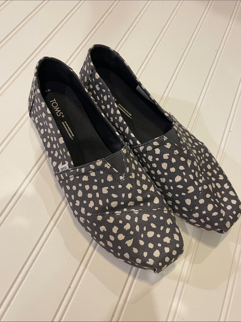 TOMS Women’s Black Canvas Slip-Ons with White Spot Print